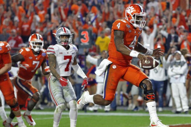 Clemson quarterback Deshaun Watson (4) runs in for a touchdown as Ohio State safety Damon Webb (7) watches during the second half of the Fiesta Bowl NCAA college football game, Saturday, Dec. 31, 2016, in Glendale, Ariz. (AP Photo/Ross D. Franklin)