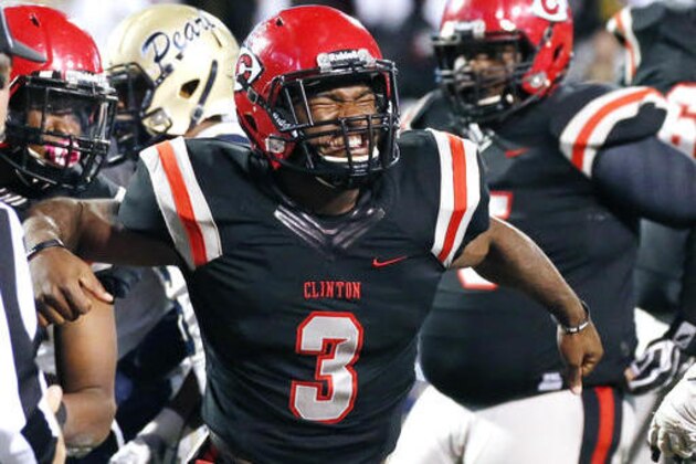 Clinton's quarterback Cam Akers (3) celebrates his touchdown in the first half of the MHSAA Class 6A football championship game against Pearl in Starkville, Miss., Friday, Dec. 2, 2016. (AP Photo/Rogelio V. Solis)