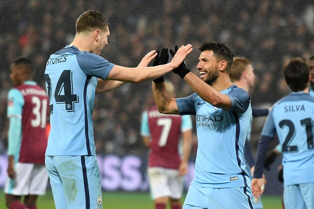 Manchester City's Argentinian striker Sergio Aguero (3rd R) celebrates with Manchester City's English defender John Stones after scoring their fourth goal during the English FA cup third round football match between West Ham United and Manchester City at the London Stadium in east London on January 6, 2016.  / AFP / Justin TALLIS / RESTRICTED TO EDITORIAL USE. No use with unauthorized audio, video, data, fixture lists, club/league logos or 'live' services. Online in-match use limited to 75 images, no video emulation. No use in betting, games or single club/league/player publications.  /         (Photo credit should read JUSTIN TALLIS/AFP/Getty Images)