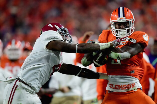 GLENDALE, AZ - JANUARY 11:  Artavis Scott #3 of the Clemson Tigers runs the ball against Eddie Jackson #4 of the Alabama Crimson Tide in the fourth quarte during the 2016 College Football Playoff National Championship Game at University of Phoenix Stadium on January 11, 2016 in Glendale, Arizona.  (Photo by Harry How/Getty Images)