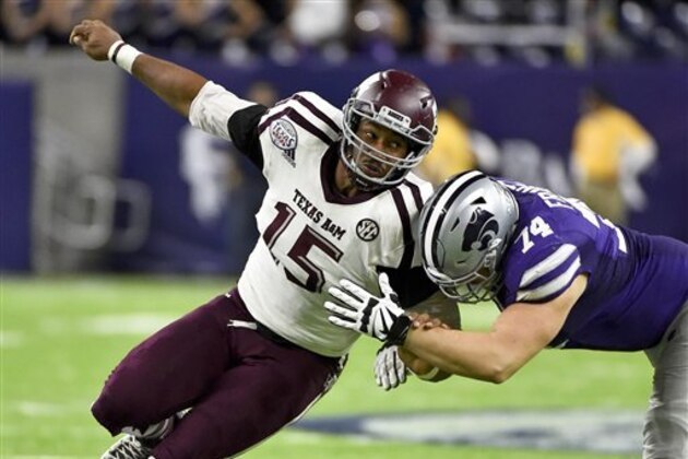 Texas A&M defensive lineman Myles Garrett (15) tries to get around Kansas State offensive lineman Scott Frantz during the second half of the Texas Bowl NCAA college football game, Wednesday, Dec. 28, 2016, in Houston. Kansas State won the game, 33-28. (AP Photo/Eric Christian Smith)