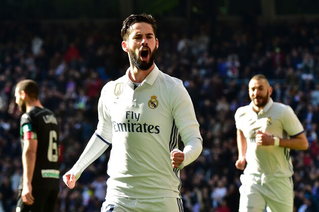 Real Madrid's midfielder Isco celebrates after scoring during the Spanish league football match Real Madrid CF vs Granada FC at the Santiago Bernabeu stadium in Madrid on January 7, 2017. / AFP / GERARD JULIEN        (Photo credit should read GERARD JULIEN/AFP/Getty Images)