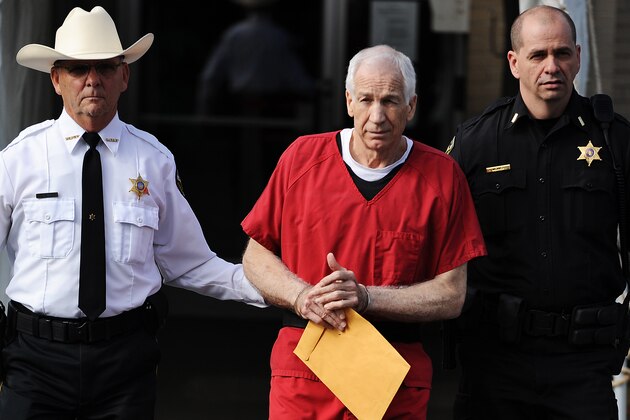BELLEFONTE, PA - OCTOBER 09: Former Penn State assistant football coach Jerry Sandusky (C) leaves the Centre County Courthouse after being sentenced in his child sex abuse case on October 9, 2012 in Bellefonte, Pennsylvania. The 68-year-old Sandusky was sentenced to at least 30 years and not more that 60 years in prison for his conviction in June on 45 counts of child sexual abuse, including while he was the defensive coordinator for the Penn State college football team. (Photo by Patrick Smith/Getty Images)