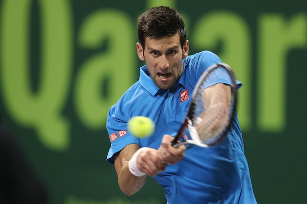 Serbia's Novak Djokovic returns the ball to Britain's Andy Murray during their final tennis match at the ATP Qatar Open in Doha on January 7, 2017. / AFP / KARIM JAAFAR        (Photo credit should read KARIM JAAFAR/AFP/Getty Images)