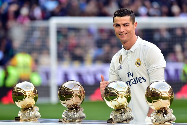 Real Madrid's Portuguese forward Cristiano Ronaldo poses with his four Ballon d'Or France Football trophies before the Spanish league football match Real Madrid CF vs Granada FC at the Santiago Bernabeu stadium in Madrid on January 7, 2017. / AFP / GERARD JULIEN        (Photo credit should read GERARD JULIEN/AFP/Getty Images)