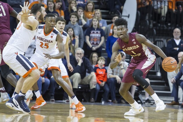 CHARLOTTESVILLE, VA - DECEMBER 31: Jonathan Isaac #1 of the Florida State Seminoles drives the ball past Jack Salt #33 and Mamadi Diakite #25 of the Virginia Cavaliers during a game at John Paul Jones Arena on December 31, 2016 in Charlottesville, Virginia. (Photo by Chet Strange/Getty Images)