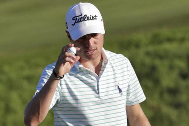 Justin Thomas tips his cap after making his birdie putt on the 17th green during the second round of the Tournament of Champions golf event, Friday, Jan. 6, 2017, at Kapalua Plantation Course in Kapalua, Hawaii. (AP Photo/Matt York)
