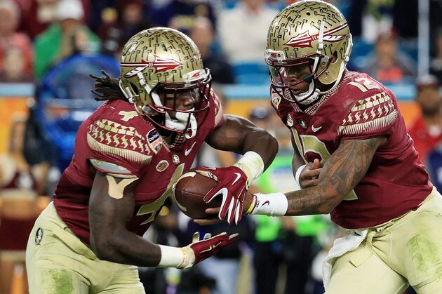 MIAMI GARDENS, FL - DECEMBER 30:  Deondre Francois #12 hands off to Dalvin Cook #4 of the Florida State Seminoles in the first half against the Michigan Wolverines during the Capitol One Orange Bowl at Sun Life Stadium on December 30, 2016 in Miami Gardens, Florida.  (Photo by Mike Ehrmann/Getty Images)