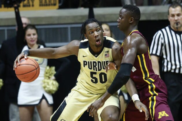 Purdue forward Caleb Swanigan (50) drives against Minnesota center Bakary Konate in the first half of an NCAA college basketball game, Sunday, Jan. 1, 2017, in West Lafayette, Ind. (AP Photo/R Brent Smith)