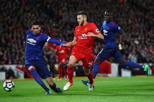 LIVERPOOL, ENGLAND - OCTOBER 17:  Adam Lallana of Liverpool is challenged by Chris Smalling of Manchester United during the Premier League match between Liverpool and Manchester United at Anfield on October 17, 2016 in Liverpool, England.  (Photo by Clive Brunskill/Getty Images)
