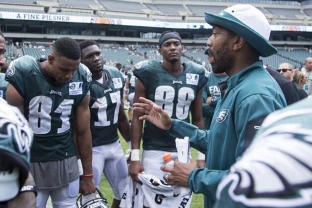 Philadelphia Eagles wide receivers coach Greg Lewis, right, talks things over with his unit during practice at NFL football training camp, Sunday, July 31, 2016, in Philadelphia. (AP Photo/Chris Szagola)