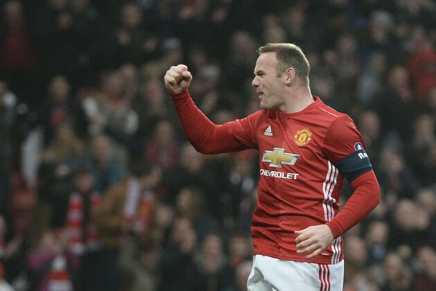 Manchester United's English striker Wayne Rooney celebrates scoring the opening goal and equalling Bobby Charlton's Manchester United all-time scoring record during the English FA Cup third round football match between Manchester United and Reading at Old Trafford in Manchester, north west England, on January 7, 2017. / AFP / Oli SCARFF / RESTRICTED TO EDITORIAL USE. No use with unauthorized audio, video, data, fixture lists, club/league logos or 'live' services. Online in-match use limited to 75 images, no video emulation. No use in betting, games or single club/league/player publications.  /         (Photo credit should read OLI SCARFF/AFP/Getty Images)