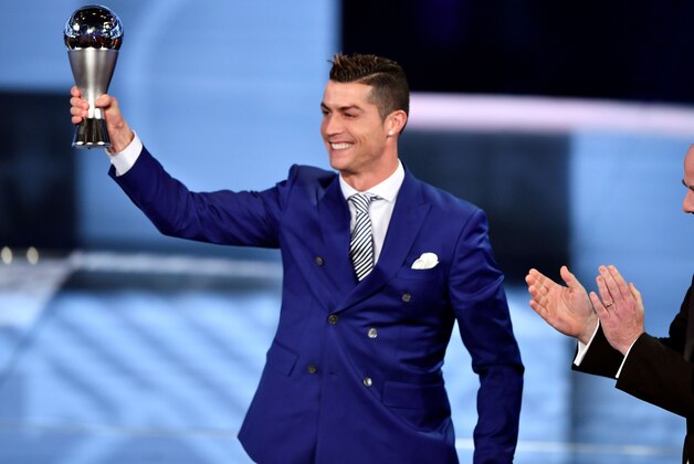 Real Madrid and Portugal's forward Cristiano Ronaldo (L) holds his trophy after winning the The Best FIFA Mens Player of 2016 Award next to FIFA president Gianni Infantino during The Best FIFA Football Awards ceremony, on January 9, 2017 in Zurich. / AFP / Fabrice COFFRINI (Photo credit should read FABRICE COFFRINI/AFP/Getty Images) Real Madrid and Portugal's forward Cristiano Ronaldo (L) holds his trophy after winning the The Best FIFA Mens Player of 2016 Award next to FIFA president Gianni Infantino during The Best FIFA Football Awards ceremony, on January 9, 2017 in Zurich. / AFP / Fabrice COFFRINI (Photo credit should read FABRICE COFFRINI/AFP/Getty Images)