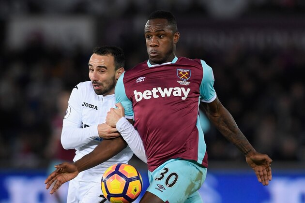 SWANSEA, WALES - DECEMBER 26:  Leon Britton of Swansea City (l) challenges Michail Antonio of West Ham United during the Premier League match between Swansea City and West Ham United at Liberty Stadium on December 26, 2016 in Swansea, Wales.  (Photo by Stu Forster/Getty Images)