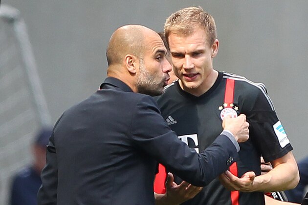 Bayern Munich's Spanish head coach Pep Guardiola (L) talks with Bayern Munich's defender Holger Badstuber during the German first division Bundesliga football match 1899 Hoffenheim vs FC Bayern Munich in Sinsheim, southern Germany, on April 18, 2015. AFP PHOTO / DANIEL ROLAND

RESTRICTIONS - DFL RULES TO LIMIT THE ONLINE USAGE DURING MATCH TIME TO 15 PICTURES PER MATCH. IMAGE SEQUENCES TO SIMULATE VIDEO IS NOT ALLOWED AT ANY TIME. FOR FURTHER QUERIES PLEASE CONTACT DFL DIRECTLY AT + 49 69 650050.        (Photo credit should read DANIEL ROLAND/AFP/Getty Images)