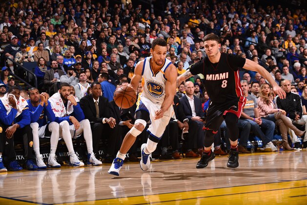OAKLAND, CA - JANUARY 10:  Stephen Curry #30 of the Golden State Warriors drives to the basket against Tyler Johnson #8 of the Miami Heat during a game on January 10, 2017 at ORACLE Arena in Oakland, California. NOTE TO USER: User expressly acknowledges and agrees that, by downloading and/or using this photograph, user is consenting to the terms and conditions of Getty Images License Agreement. Mandatory Copyright Notice: Copyright 2017 NBAE (Photo by Noah Graham/NBAE via Getty Images)
