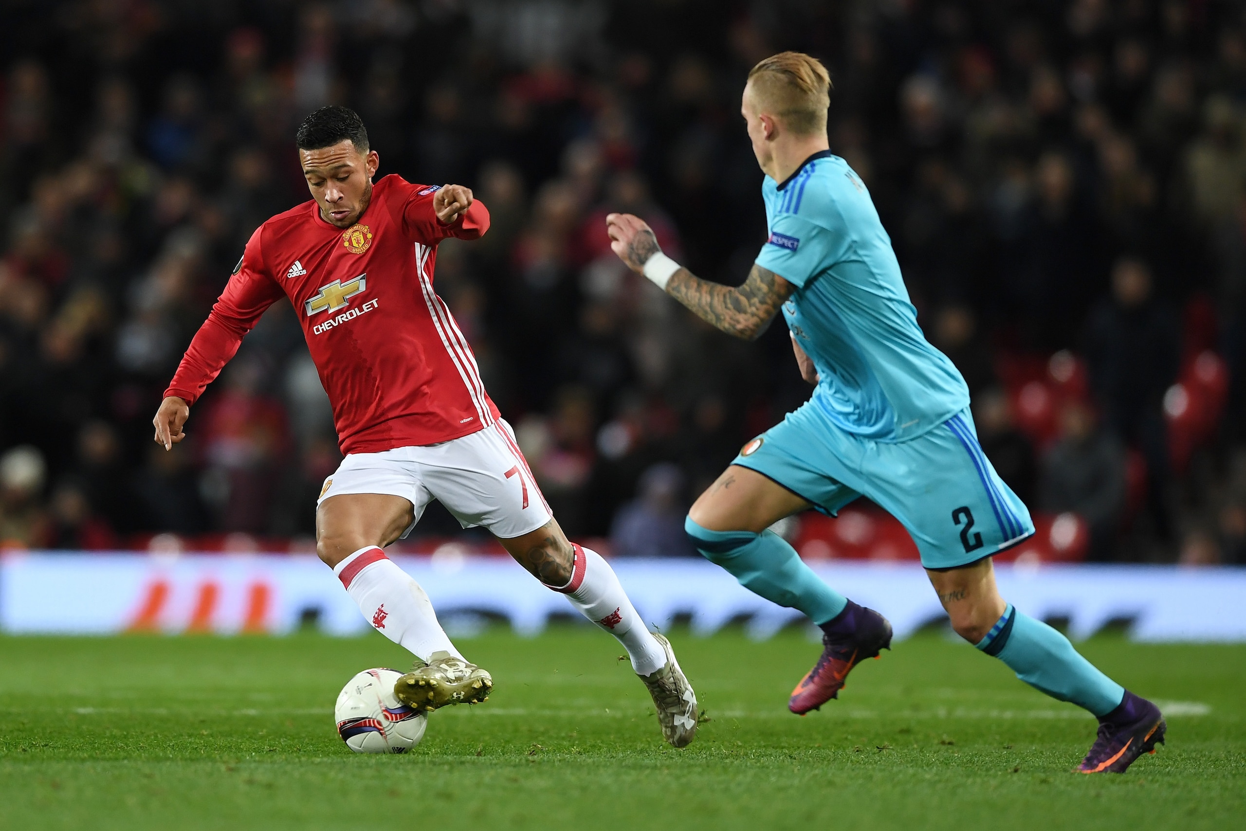 MANCHESTER, ENGLAND - NOVEMBER 24:  Memphis Depay of Manchester United is watched by Rick Karsdorp of Feyenoord during the UEFA Europa League Group A match between Manchester United FC and Feyenoord at Old Trafford on November 24, 2016 in Manchester, England.  (Photo by Gareth Copley/Getty Images)