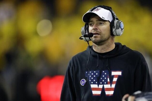 FILE - In this Nov. 9, 2013, file photo, Washington's defensive coordinator Justin Wilcox wears a sweatshirt and cap with a special team logo to honor veterans as he coaches against Colorado in the second half of an NCAA college football game in Seattle. Wisconsin and coach Paul Chryst formally introduced Wilcox as the Badgers' new defensive coordinator on Monday, Feb. 1, 2016. (AP Photo/Ted S. Warren, File)