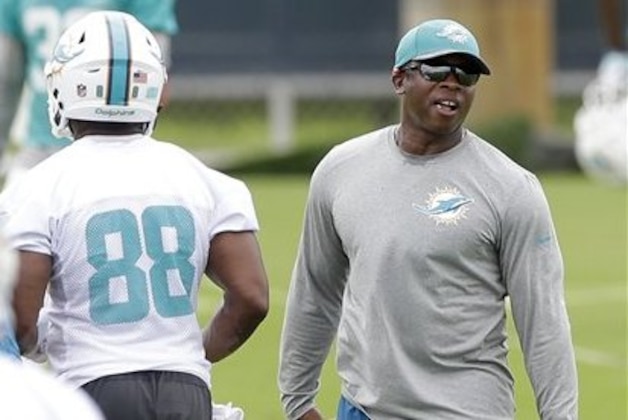 Miami Dolphins defensive coordinator Vance Joseph, right, watches players during practice at the team's NFL football training facility, Monday, June 6, 2016, in Davie, Fla. As Joseph began to evaluate the Dolphins’ front four, linebackers and secondary in offseason drills, he felt a little uncomfortable with his own position. The first-time defensive coordinator was unsure about how to situate himself or spend his time. (AP Photo/Alan Diaz)