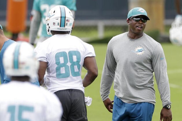FILE - In this  Monday, June 6, 2016 file photo, Miami Dolphins defensive coordinator Vance Joseph, right, watches players during practice at the team's NFL football training facility in Davie, Fla. The 2016 Miami Dolphins have something in common with the franchise’s 1984 Super Bowl team, and in this case, that’s not good. Miami has allowed 971 yards in the past two games, the most in a two-game stretch for a Dolphins team in 32 years (AP Photo/Alan Diaz, File)
