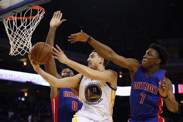 OAKLAND, CA - JANUARY 12:  Klay Thompson #11 of the Golden State Warriors goes up for a shot against Andre Drummond #0 and Stanley Johnson #7 of the Detroit Pistons at ORACLE Arena on January 12, 2017 in Oakland, California.  NOTE TO USER: User expressly acknowledges and agrees that, by downloading and or using this photograph, User is consenting to the terms and conditions of the Getty Images License Agreement.  (Photo by Ezra Shaw/Getty Images)