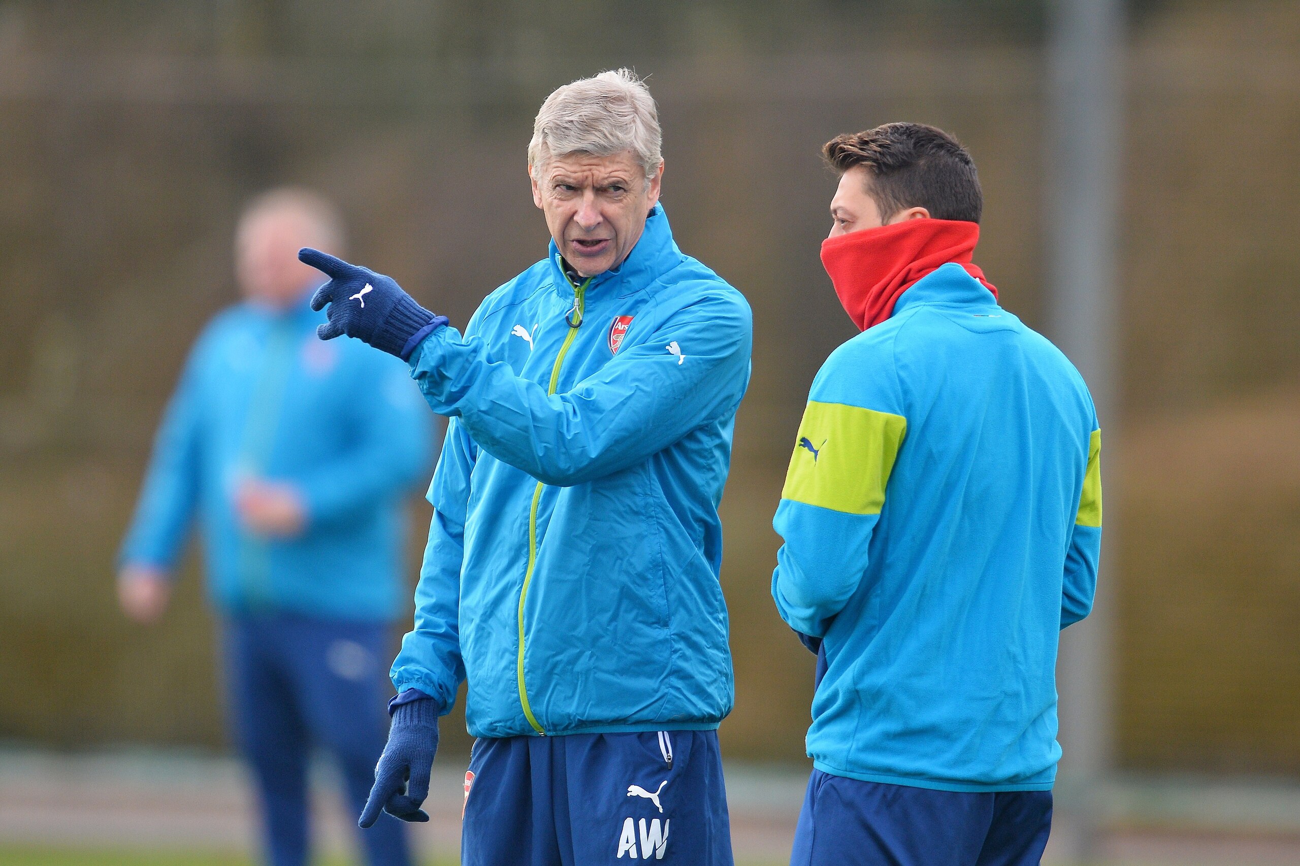 Arsenal's French manager Arsene Wenger (L) speaks with Arsenal's German midfielder Mesut Ozil (R) as they attend a training session at Arsenal's training ground in London Colney, north of London, England on February 24, 2015, ahead of the UEFA Champions League round of 16 first leg football match against AS Monaco on February 25 in London. AFP PHOTO / GLYN KIRK        (Photo credit should read GLYN KIRK/AFP/Getty Images)