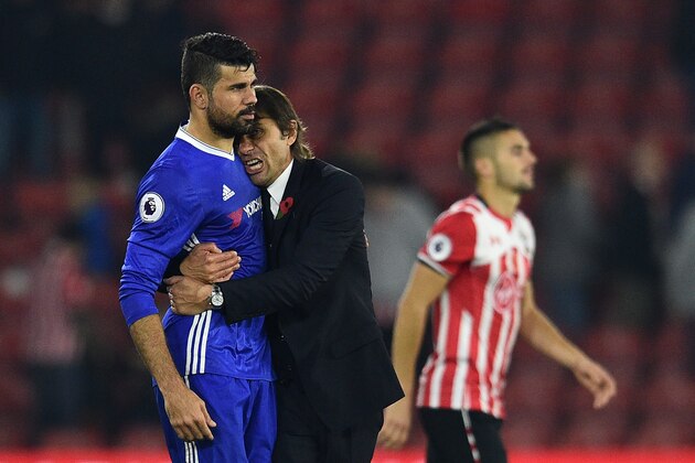 Chelsea's Italian head coach Antonio Conte (2nd L) embraces Chelsea's Brazilian-born Spanish striker Diego Costa (L) after the English Premier League football match between Southampton and Chelsea at St Mary's Stadium in Southampton, southern England on October 30, 2016.
Chelsea won the game 2-0. / AFP / GLYN KIRK / RESTRICTED TO EDITORIAL USE. No use with unauthorized audio, video, data, fixture lists, club/league logos or 'live' services. Online in-match use limited to 75 images, no video emulation. No use in betting, games or single club/league/player publications.  /         (Photo credit should read GLYN KIRK/AFP/Getty Images)