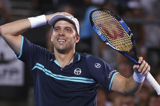 Gilles Muller of Luxembourg celebrates his win over Britain's Daniel Evans in the men's singles final at the Sydney International tennis tournament in Sydney, Australia, Saturday, Jan. 14, 2017. (AP Photo/Rick Rycroft)