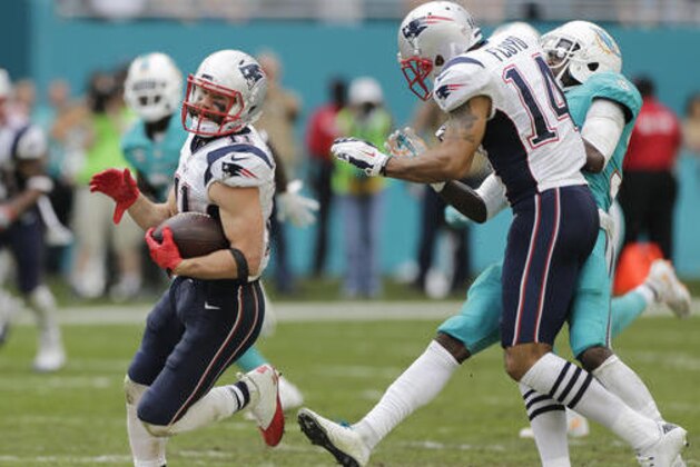 New England Patriots wide receiver Julian Edelman (11) runs for a touchdown as wide receiver Michael Floyd (14) bumps Miami Dolphins cornerback Tony Lippett (36) out of the way, during the second half of an NFL football game, Sunday, Jan. 1, 2017, in Miami Gardens, Fla. (AP Photo/Alan Diaz)