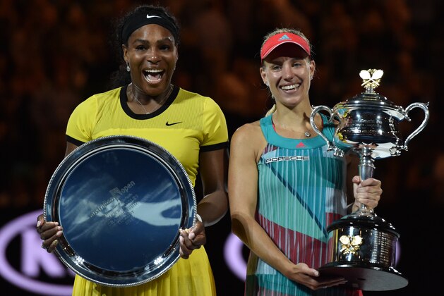 Germany's Angelique Kerber (R) holds The Daphne Akhurst Memorial Cup as she celebrates after victory her women's singles final match against Serena Williams of the US (L) on day thirteen of the 2016 Australian Open tennis tournament in Melbourne on January 30, 2016. AFP PHOTO / SAEED KHAN-- IMAGE RESTRICTED TO EDITORIAL USE - STRICTLY NO COMMERCIAL USE / AFP / SAEED KHAN        (Photo credit should read SAEED KHAN/AFP/Getty Images)