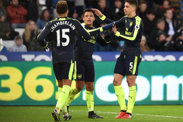SWANSEA, WALES - JANUARY 14: Alexis Sanchez of Arsenal celebrates scoring his sides fourth goal with Alex Oxlade-Chamberlain of Arsenal (L) and Gabriel of Arsenal (R) during the Premier League match between Swansea City and Arsenal at Liberty Stadium on January 14, 2017 in Swansea, Wales.  (Photo by Tony Marshall/Getty Images)