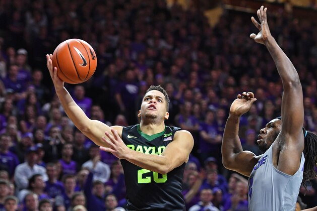 MANHATTAN, KS - JANUARY 14:  Guard Manu Lecomte #20 of the Baylor Bears drives to the basket against forward D.J. Johnson #4 of the Kansas State Wildcats during the first half on January 14, 2017 at Bramlage Coliseum in Manhattan, Kansas.  (Photo by Peter G. Aiken/Getty Images)