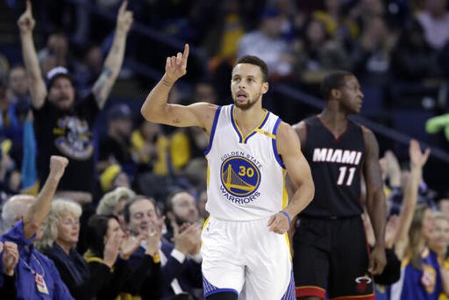 Golden State Warriors' Stephen Curry (30) points after scoring against the Miami Heat during the first half of an NBA basketball game Tuesday, Jan. 10, 2017, in Oakland, Calif. (AP Photo/Marcio Jose Sanchez)