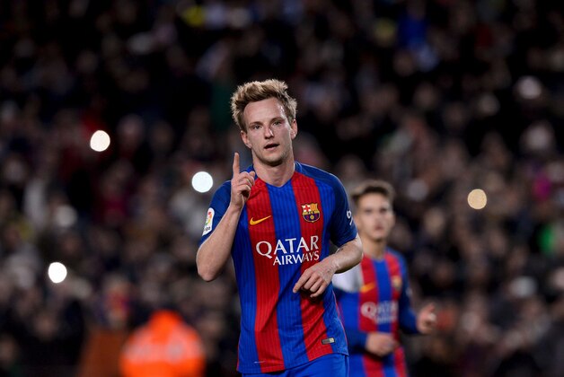 Barcelona's Croatian midfielder Ivan Rakitic celebrates after scoring during the Spanish Copa del Rey (King's Cup) round of 32 second leg football match FC Barcelona vs Hercules CF at the Camp Nou stadium in Barcelona on December 21, 2016. / AFP / JOSEP LAGO        (Photo credit should read JOSEP LAGO/AFP/Getty Images)
