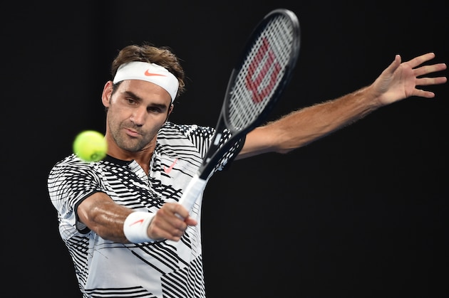 Switzerland's Roger Federer hits a return against Austria's Jurgen Malzer during their men's singles match on day one of the Australian Open tennis tournament in Melbourne on January 16, 2017. / AFP / PETER PARKS        (Photo credit should read PETER PARKS/AFP/Getty Images)