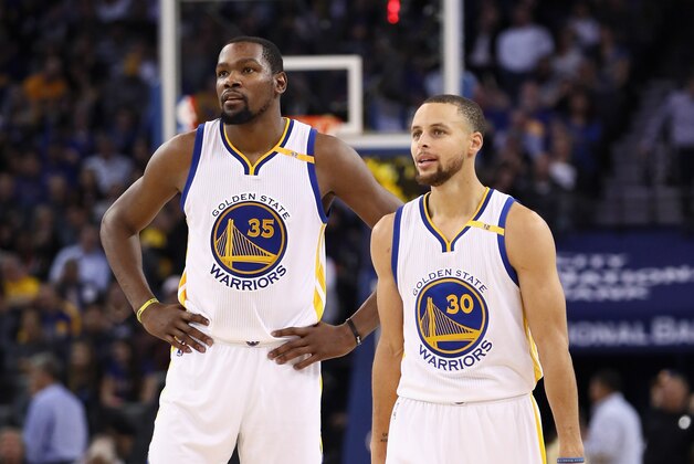 OAKLAND, CA - JANUARY 12:  Stephen Curry #30 of the Golden State Warriors stands next to Kevin Durant #35 of the Golden State Warriors during their game against the Detroit Pistons at ORACLE Arena on January 12, 2017 in Oakland, California.  NOTE TO USER: User expressly acknowledges and agrees that, by downloading and or using this photograph, User is consenting to the terms and conditions of the Getty Images License Agreement.  (Photo by Ezra Shaw/Getty Images)