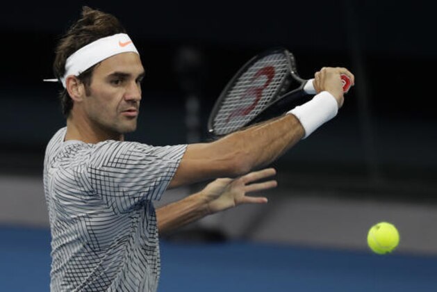 Switzerland's Roger Federer makes a backhand during a practice session ahead of the Australian Open tennis championships in Melbourne, Australia, Sunday, Jan. 15, 2017. (AP Photo/Kin Cheung )