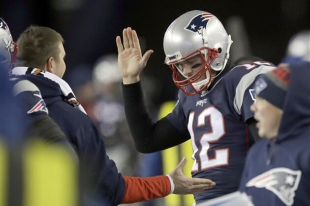 New England Patriots quarterback Tom Brady (12) celebrates a touchdown with teammates on the sideline during the first half of an NFL divisional playoff football game against the Houston Texans, Saturday, Jan. 14, 2017, in Foxborough, Mass. (AP Photo/Charles Krupa)