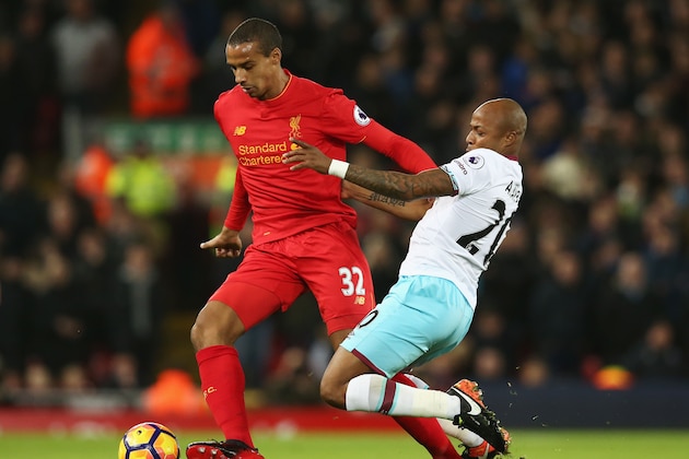 LIVERPOOL, ENGLAND - DECEMBER 11: Joel Matip of Liverpool and Andre Ayew of West Ham United compete for the ball during the Premier League match between Liverpool and West Ham United at Anfield on December 11, 2016 in Liverpool, England.  (Photo by Jan Kruger/Getty Images)