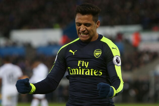 Arsenal's Chilean striker Alexis Sanchez celebrates scoring his team's fourth goal during the English Premier League football match between Swansea City and Arsenal at The Liberty Stadium in Swansea, south Wales on January 14, 2017. / AFP / Geoff CADDICK / RESTRICTED TO EDITORIAL USE. No use with unauthorized audio, video, data, fixture lists, club/league logos or 'live' services. Online in-match use limited to 75 images, no video emulation. No use in betting, games or single club/league/player publications.  /         (Photo credit should read GEOFF CADDICK/AFP/Getty Images)