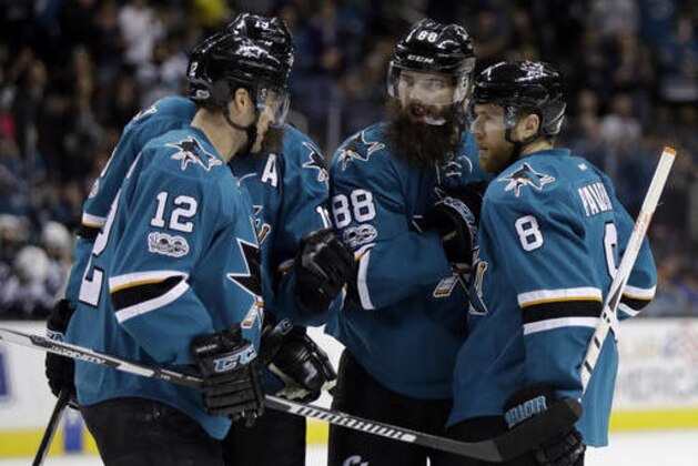 San Jose Sharks' Brent Burns (88) celebrates his goal with teammates Joe Pavelski (8), Patrick Marleau (12) and Joe Thornton, second from left, during the second period of an NHL hockey game against the Winnipeg Jets, Monday, Jan. 16, 2017, in San Jose, Calif. (AP Photo/Marcio Jose Sanchez)