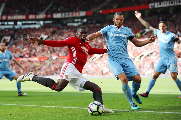 MANCHESTER, ENGLAND - OCTOBER 02:  Paul Pogba of Manchester United (L) shoots while Erik Pieters of Stoke City (R) attempts to block the shot during the Premier League match between Manchester United and Stoke City at Old Trafford on October 2, 2016 in Manchester, England.  (Photo by Clive Brunskill/Getty Images)