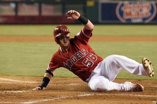 Los Angeles Angels' Kole Calhoun slides into home to score off an RBI single by Mike Trout, not pictured, during the first inning of a baseball game against the Oakland Athletics in Anaheim, Calif., Tuesday, Sept. 27, 2016. (AP Photo/Kelvin Kuo)
