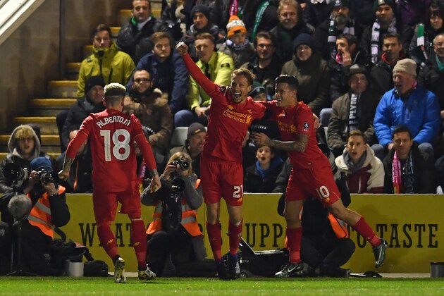 Liverpool's Brazilian midfielder Lucas Leiva (C) celebrates with teammates after scoring the opening goal of the English FA Cup third round replay football match between Plymouth Argyle and Liverpool at Home Park in Plymouth, south west England on January 18, 2017. / AFP / Ben STANSALL / RESTRICTED TO EDITORIAL USE. No use with unauthorized audio, video, data, fixture lists, club/league logos or 'live' services. Online in-match use limited to 75 images, no video emulation. No use in betting, games or single club/league/player publications.  /         (Photo credit should read BEN STANSALL/AFP/Getty Images)