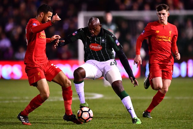 PLYMOUTH, ENGLAND - JANUARY 18:  Arnold Garita of Plymouth Argyle takes on Kevin Stewart (L) of Liverpool during The Emirates FA Cup Third Round Replay match between Plymouth Argyle and Liverpool at Home Park on January 18, 2017 in Plymouth, England.  (Photo by Dan Mullan/Getty Images)