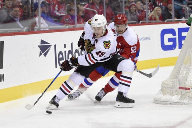 Chicago Blackhawks center Jonathan Toews (19) skates with the puck against Washington Capitals center Evgeny Kuznetsov (92), of Russia, during the second period of an NHL hockey game, Friday, Jan. 13, 2017, in Washington. (AP Photo/Nick Wass)