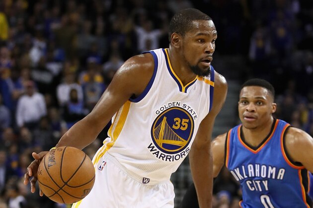 OAKLAND, CA - JANUARY 18:  Kevin Durant #35 of the Golden State Warriors dribbles past Russell Westbrook #0 of the Oklahoma City Thunder at ORACLE Arena on January 18, 2017 in Oakland, California.  NOTE TO USER: User expressly acknowledges and agrees that, by downloading and or using this photograph, User is consenting to the terms and conditions of the Getty Images License Agreement.  (Photo by Ezra Shaw/Getty Images)