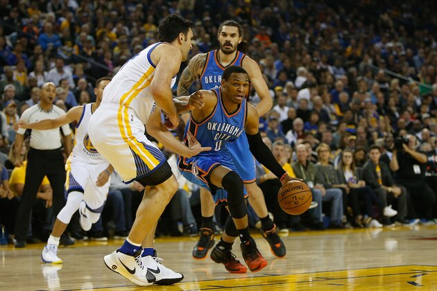 OAKLAND, CA - NOVEMBER 03: Russell Westbrook #0 of the Oklahoma City Thunder drives to the basket against Zaza Pachulia #27 of the Golden State Warriors at ORACLE Arena on November 3, 2016 in Oakland, California. NOTE TO USER: User expressly acknowledges and agrees that, by downloading and or using this photograph, user is consenting to the terms and conditions of Getty Images License Agreement. (Photo by Lachlan Cunningham/Getty Images)