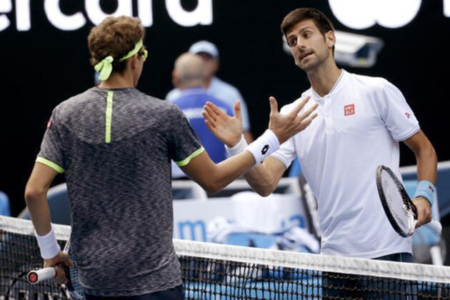 Serbia's Novak Djokovic, right, congratulates Uzbekistan's Denis Istomin after winning their second round match at the Australian Open tennis championships in Melbourne, Australia, Thursday, Jan. 19, 2017. (AP Photo/Aaron Favila)