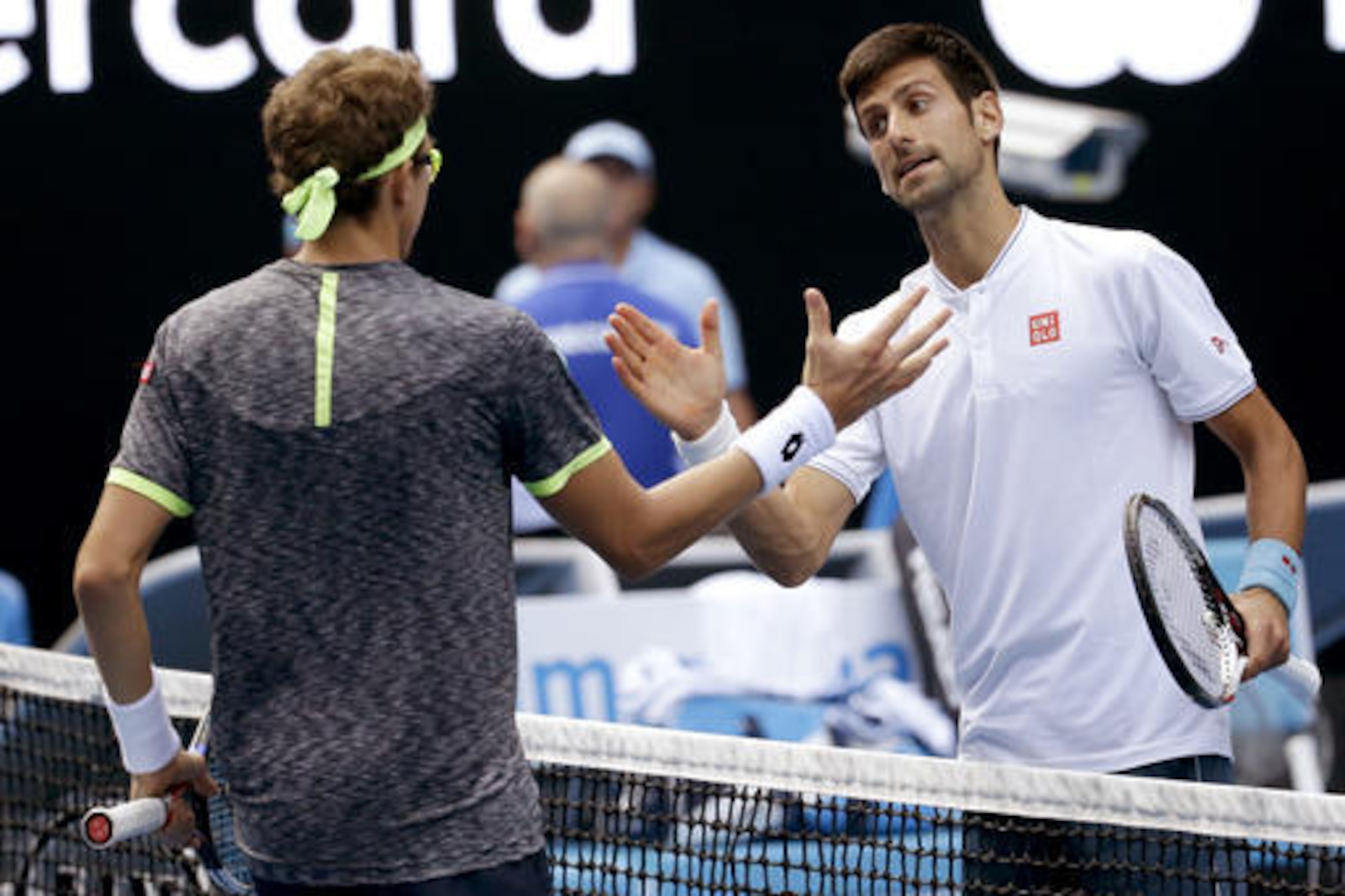 Serbia's Novak Djokovic, right, congratulates Uzbekistan's Denis Istomin after winning their second round match at the Australian Open tennis championships in Melbourne, Australia, Thursday, Jan. 19, 2017. (AP Photo/Aaron Favila)